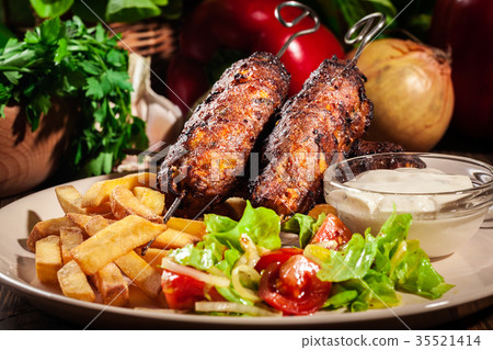 图库照片: grilled shish kebab served with fried chips