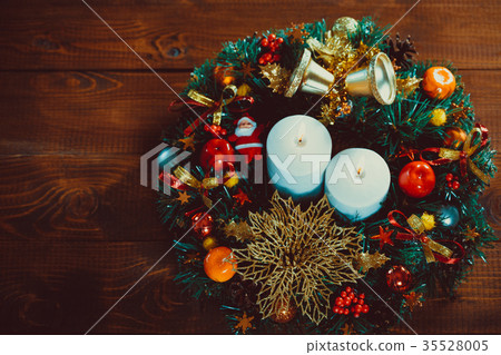 图库照片: christmas wreath with burning candles on wooden