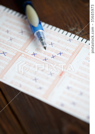 图库照片: photo on top of lottery ticket with marked numbers