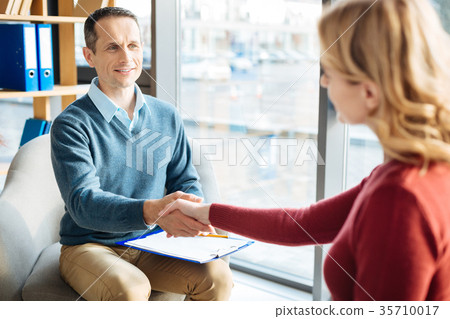 图库照片 joyful friendly man greeting his patient