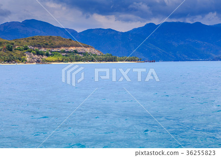 图库照片: clouds lace in blue sky above azure sea hill