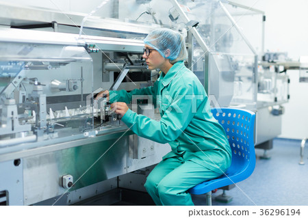 图库照片: pharmaceutical factory worker at the workplace
