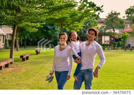 图库照片: parents and daughters go for a walk in the park.
