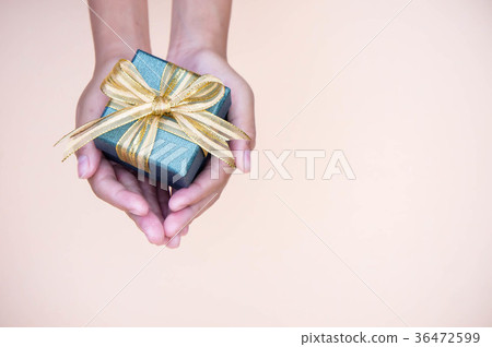 图库照片: giving gift box in with hands on special days