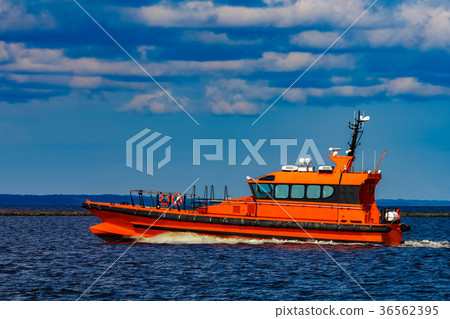 图库照片: orange pilot boat in action