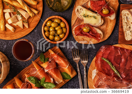 图库照片: italian food background with ham, cheese, olives.