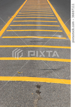 图库照片: yellow color road line on asphalt background