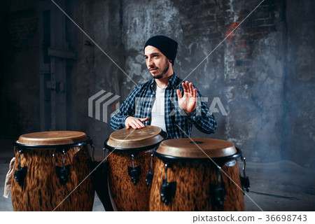 图库照片: drummer playing on wooden bongo drums, beat rhythm