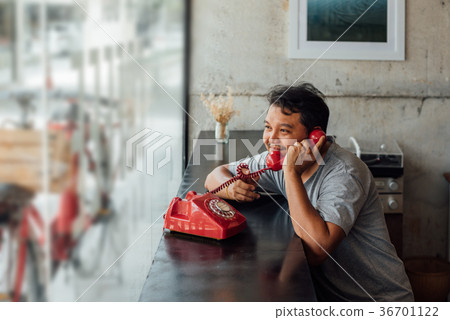 图库照片: asian man happy talk phone call in coffee shop