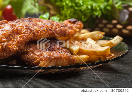 图库照片: fried fish in crispy batter with chips