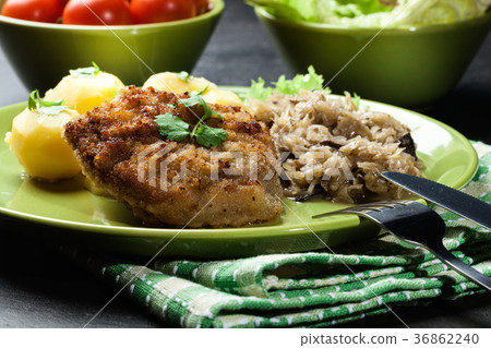 图库照片: fried pork schnitzel served with boiled potatoes