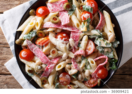 图库照片: tuscan salad of penne pasta with salami