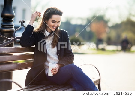 照片素材(图片): happy beautiful woman with cup of coffee sitting