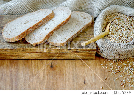 图库照片: a bag of grain and sliced bread.