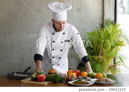 图库照片: professional chef looking at food and vegetable