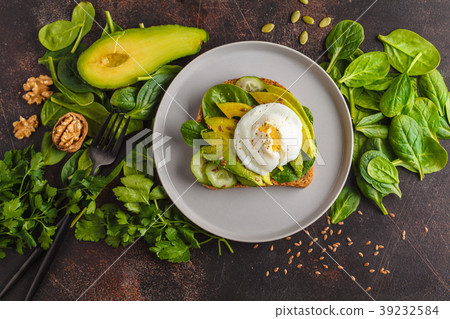 图库照片: fresh avocado breakfast with egg poached sandwich