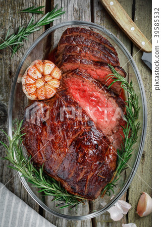 照片素材(图片): top view of a baked beef steak medium rare