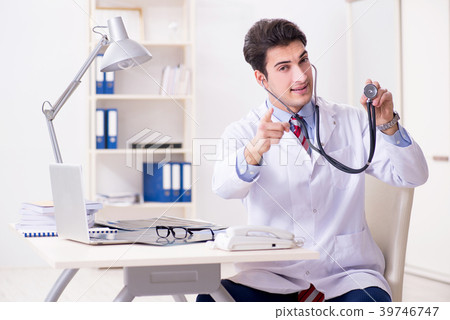 图库照片: young handsome doctor working in hospital room