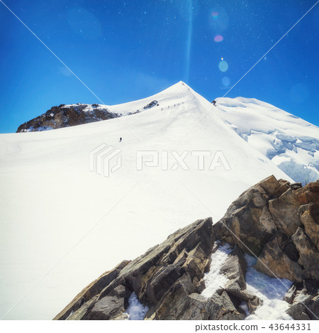 trekking to the top of mont blanc mountain in french alps