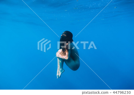 Beautiful Woman With Nude Body Dive Underwater Stock Photo