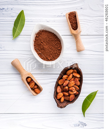 stock photo: cocoa powder and cacao beans on wooden background.