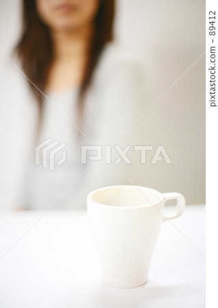 A woman looking at a cup A woman looking at a cup 89412