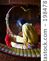 A woman playing a harp A woman playing a harp 198478