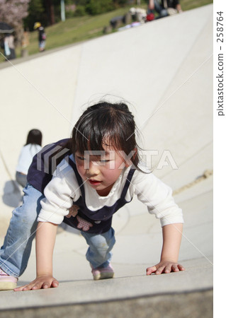 一個年輕的女孩在公園裡玩 一個年輕的女孩在公園裡玩 258764