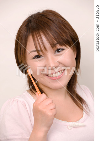 A woman with a toothbrush 315855