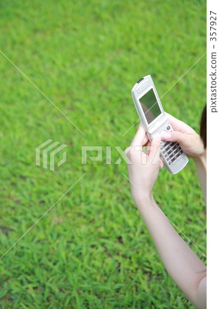 Hands with handheld and lawn 357927