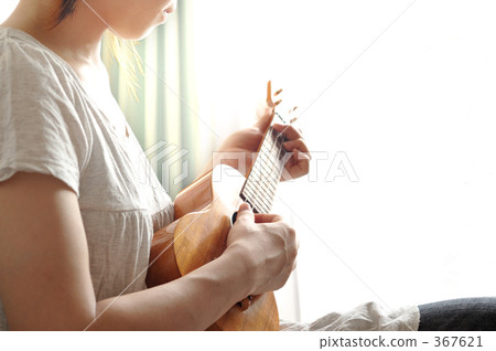A woman playing an ukulele A woman playing an ukulele 367621