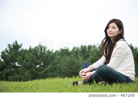 一個女人坐在草坪上 467269