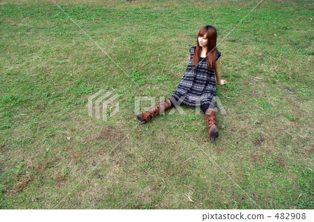 A young woman relaxing on the lawn 482908