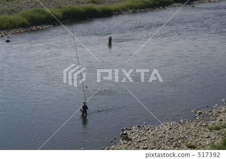 A fisherman raising a fishing rod A fisherman raising a fishing rod 517392
