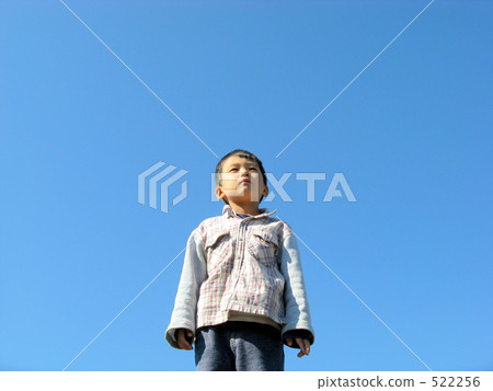 A child looking up at the sky A child looking up at the sky 522256