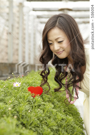 A woman smiling with a red heart A woman smiling with a red heart 586004
