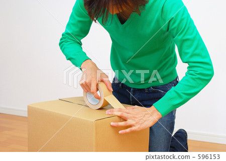 A man who sticks a gum tape to cardboard A man who sticks a gum tape to cardboard 596153