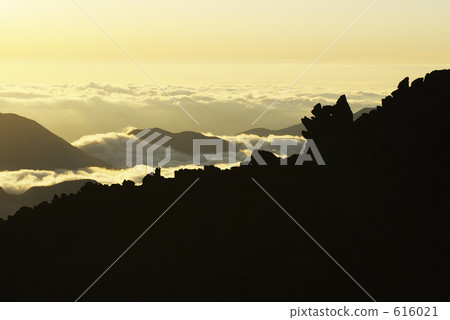 Silhouette of the sea of clouds and rocky mountains Silhouette of the sea of clouds and rocky mountains 616021