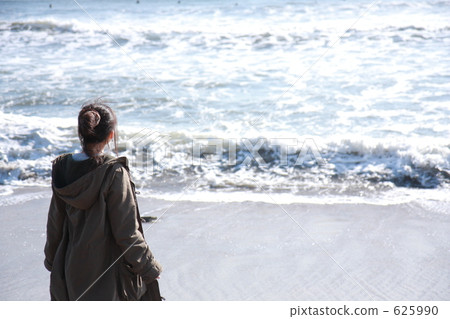 A woman looking at the sea in winter A woman looking at the sea in winter 625990
