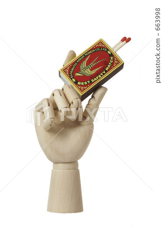 Hand of a doll with a match 663998