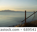 Evening scenery of the mountains, the sea and a torn fence 689541