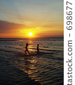 Children playing at the coast of sunset at Darwin 698677