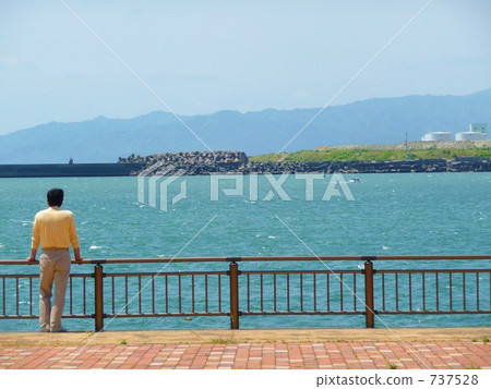 A man staring at the sea at Miyazaki Port 737528