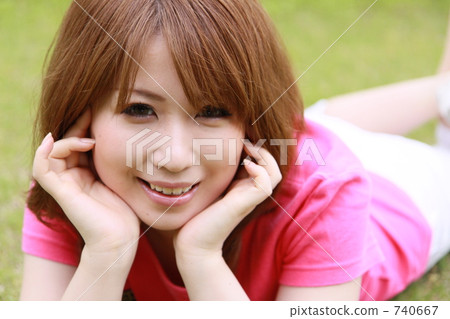 A woman lying down on the lawn A woman lying down on the lawn 740667