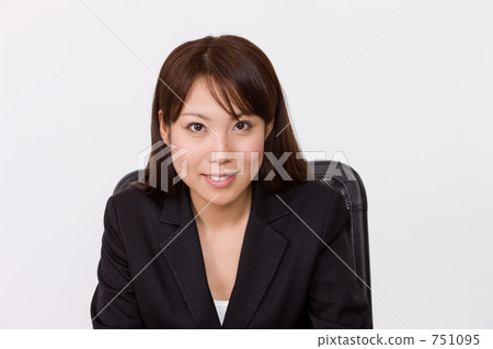 Business woman sitting in a chair Business woman sitting in a chair 751095