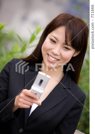 A young woman putting on a cell phone A young woman putting on a cell phone 751666