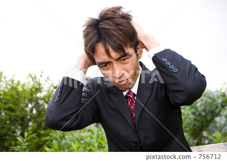 Businessman holding his head Businessman holding his head 756712