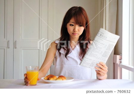 A woman reading an English newspaper A woman reading an English newspaper 760632