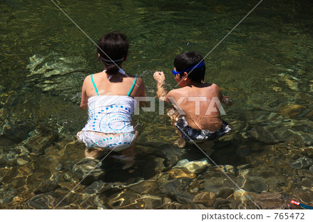outing to the riverside, playing in a river, older sister and younger brother 765472