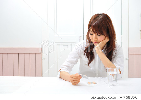 A woman with a headache medicine 768856